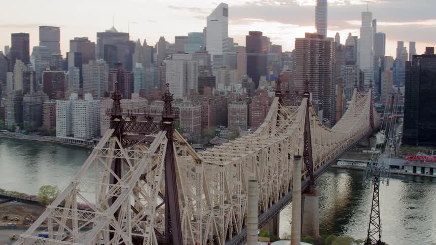 Cars travel over the bridge towards the city