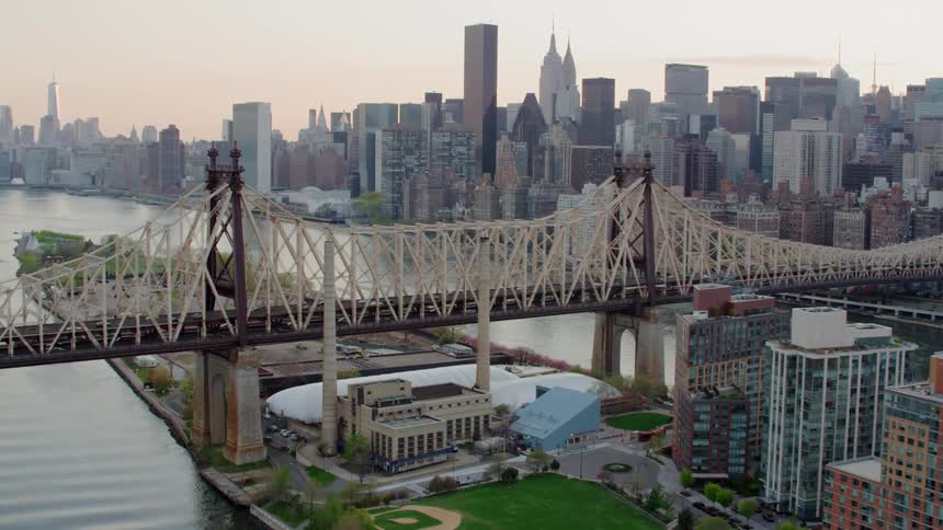 A city skyline with a bridge leading to it