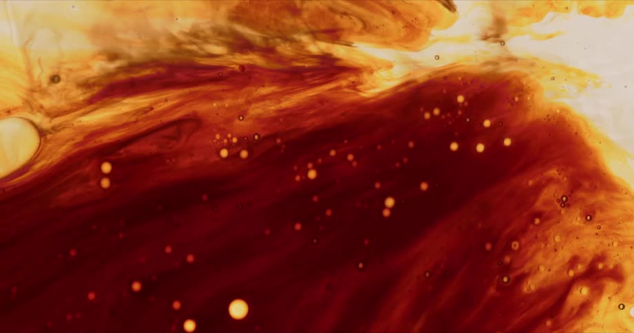 Red and orange colored fluid mixes together