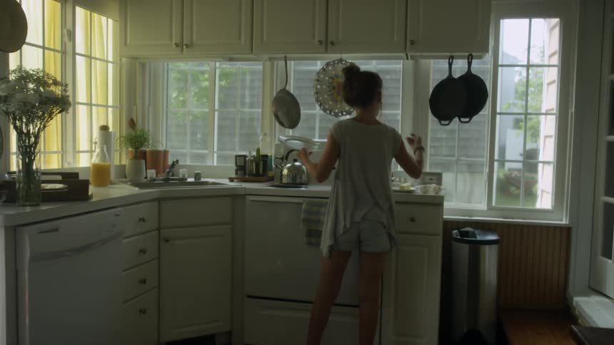 A woman cooks in the kitchen in the daytime