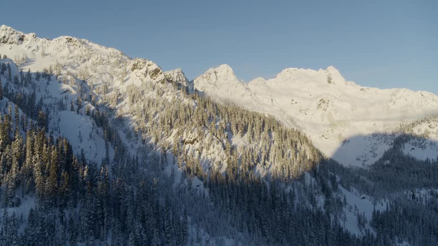 Frosty morning reveal of snow covered rugged mountain peaks