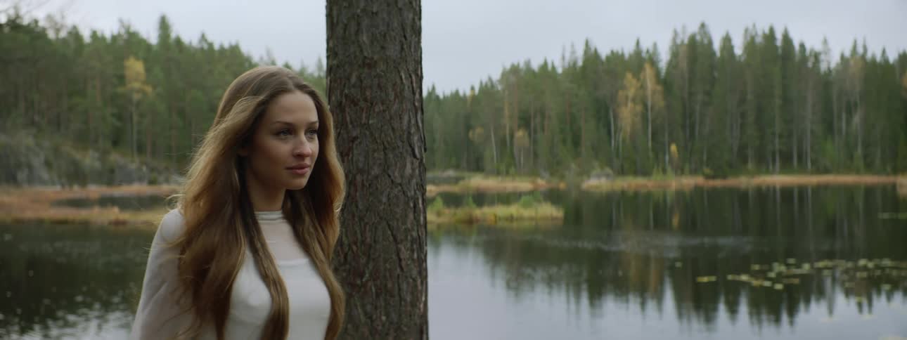 A woman walks past the lake