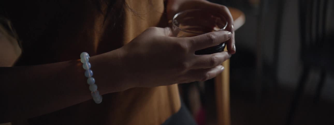 A young girl drinks a cup of tea