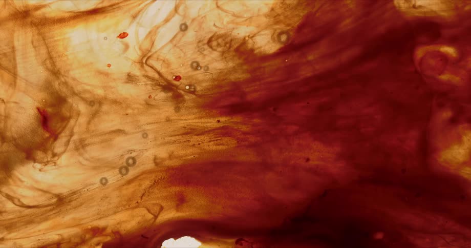 Brown fluid with bubbles and spots flows together