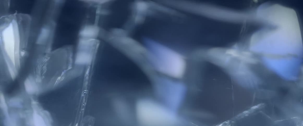Extreme close up of shards of broken glass going in and out of focus