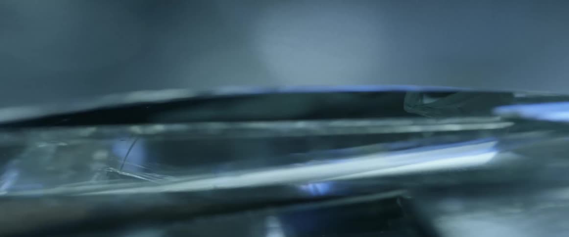 Broken glass is illuminated by flashing lights