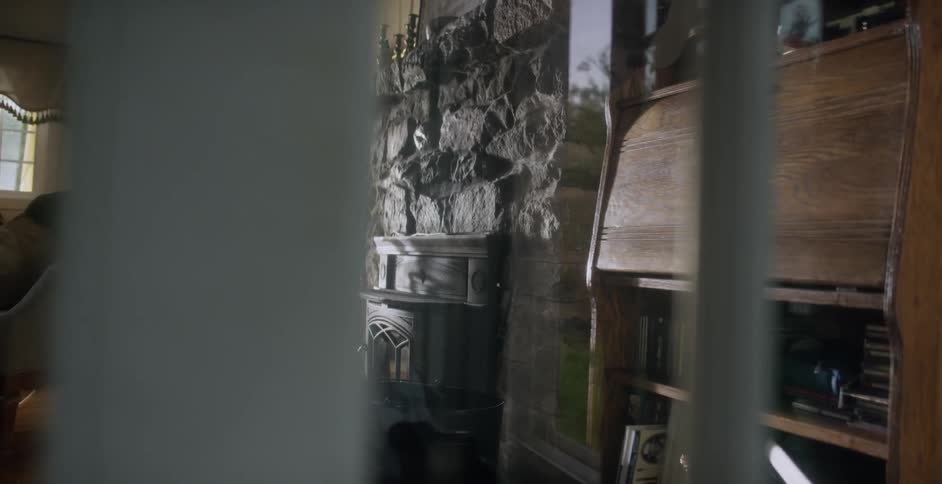 The inside of a home has a stone chimney