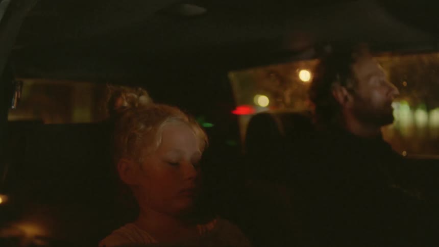 A father and daughter in a car at night