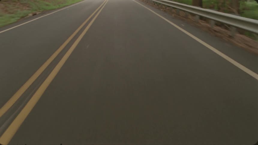 The road as seen at a fast speed in the day time