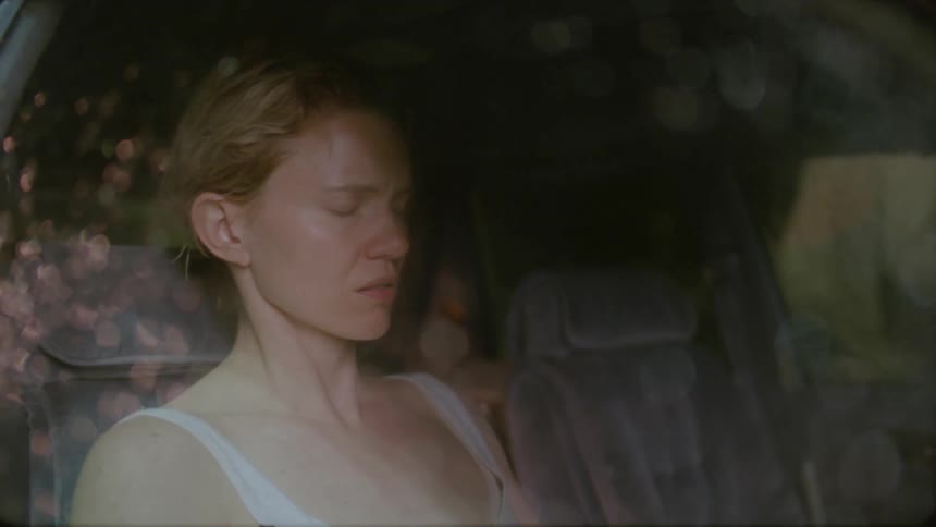 A woman flinching as a man exits a car and slams the door