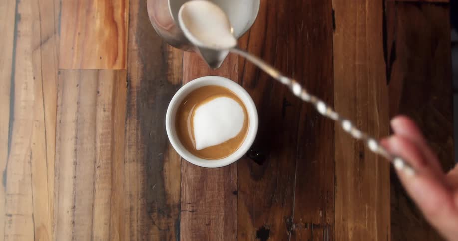 A person puts creme in the drink