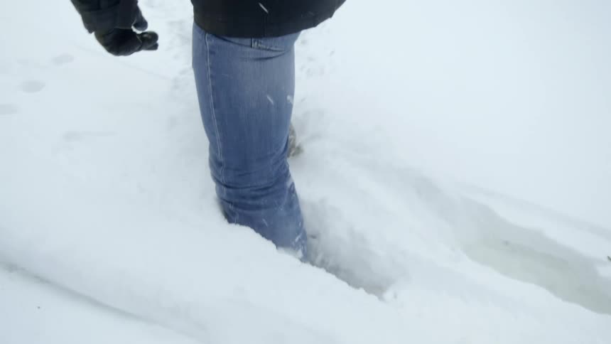 A person is hiking through the snow in winter