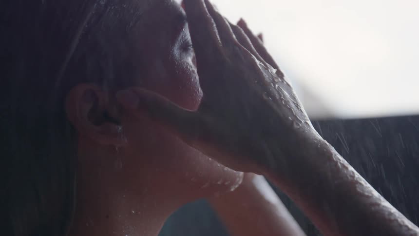 A woman is bathing in the shower