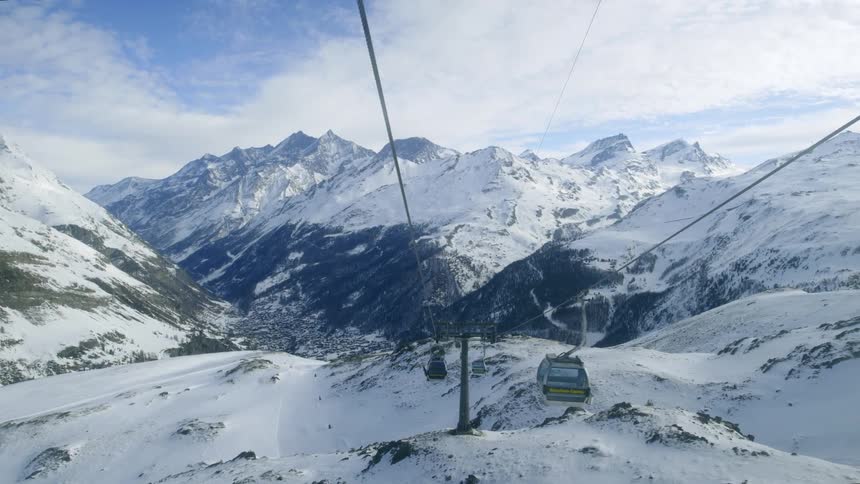 Gondola cars moving through the mountains