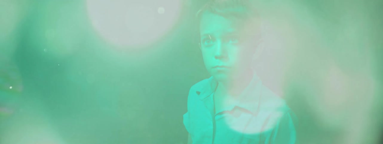 The lights flash around the child in the dark