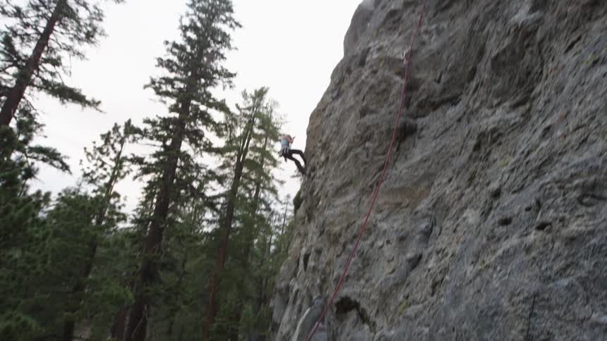 People are rock climbing in the wilderness