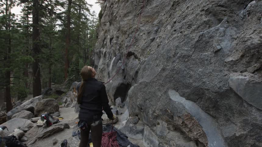 A woman is looking at a mountain outdoors