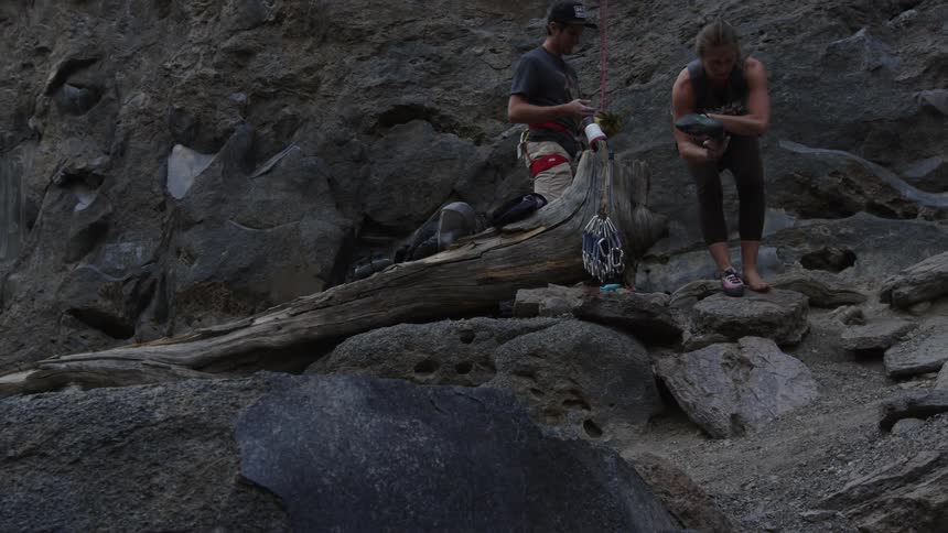 Two climbers get ready to go up a mountain cliff