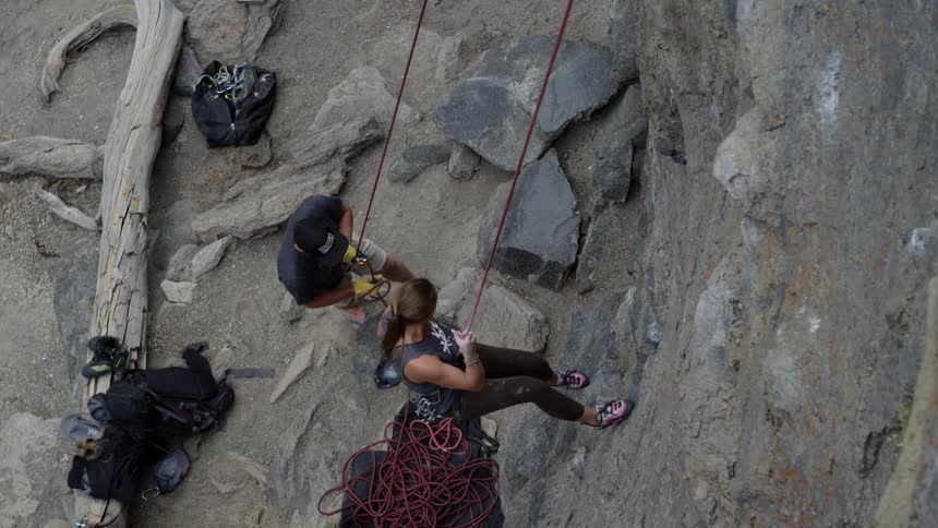 The woman climbs down the mountain