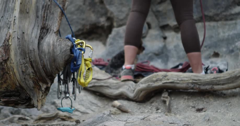 A woman is standing by rocks outdoors