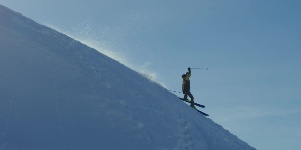 A skier nearly falls on a jump landing