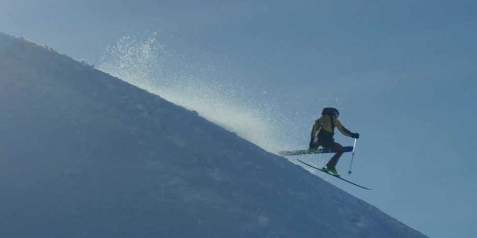 A skier lands from a jump and falls