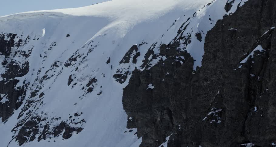 A skier attempting to descend a steep slope before falling and tumbling down through the ice