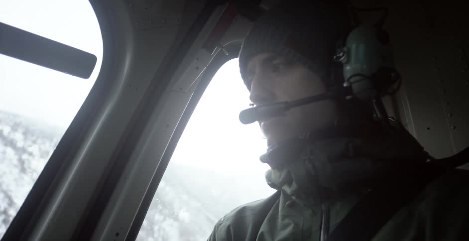 A man in an aircraft with a headset on