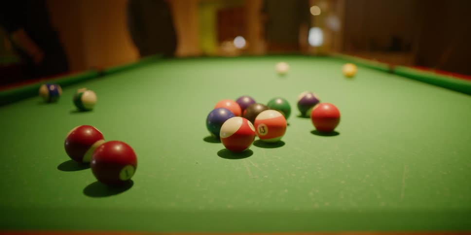 A man breaks the rack in a pool game