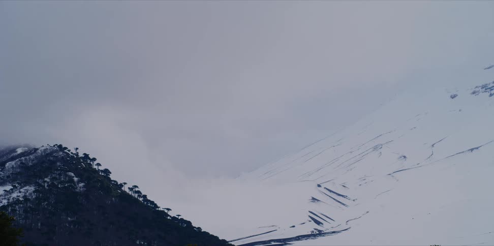 Timelapse of clouds on a snowy mountain