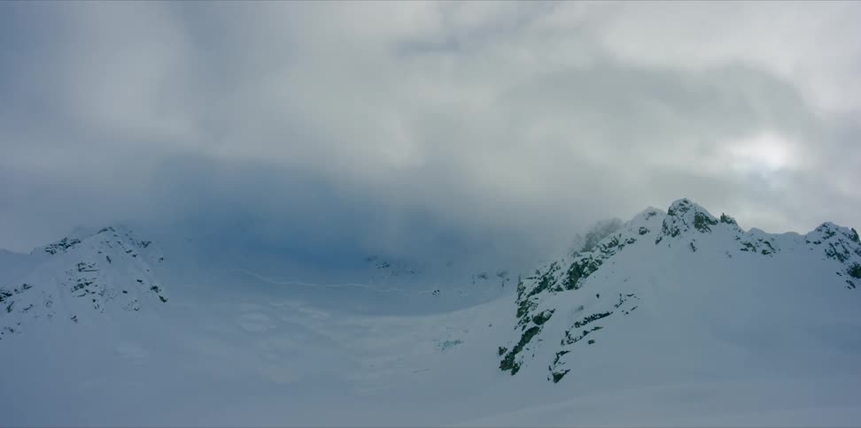 A snow covered mountain ridge in incredible light