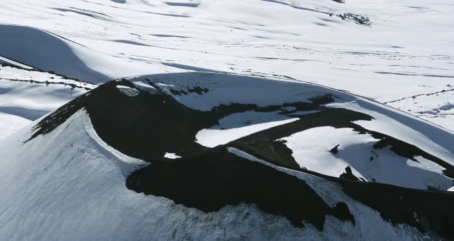 Aerial of a snowy volcano crater