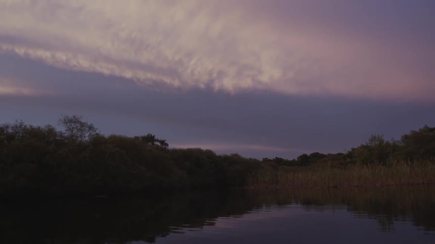 A cloudy sky over a river scene