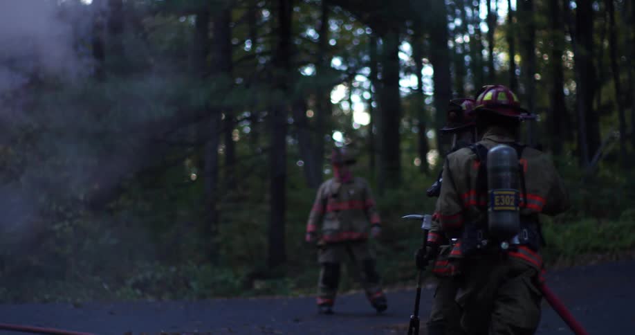 The fire fighters look at the fire