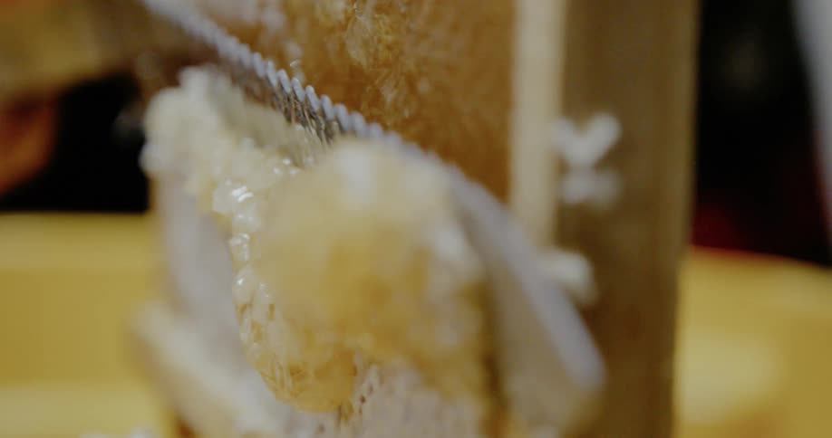 A person cuts honeycomb