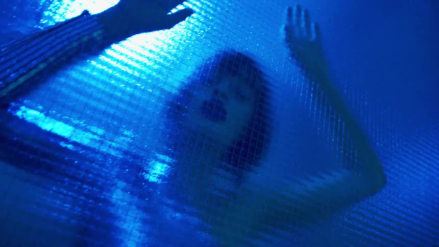 A woman dancing against a wall is displayed