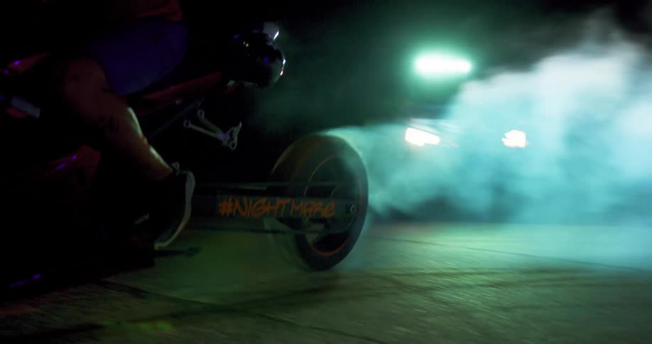 Motorcycle burns rubber as rider turns at night
