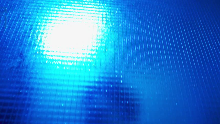 Woman dancing behind an opaque glass wall