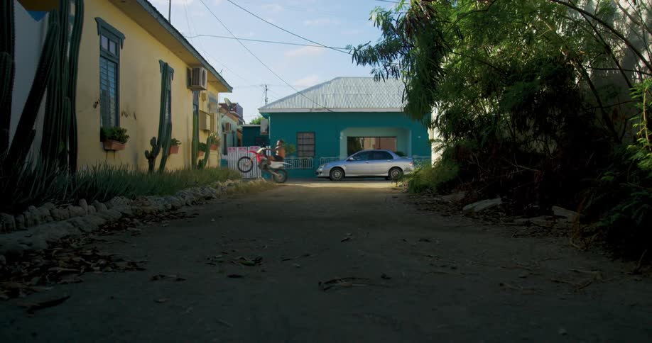 A man rides a motorbike across a street