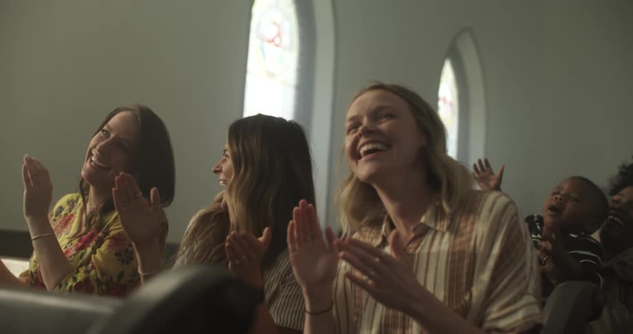 People in church clapping and laughing