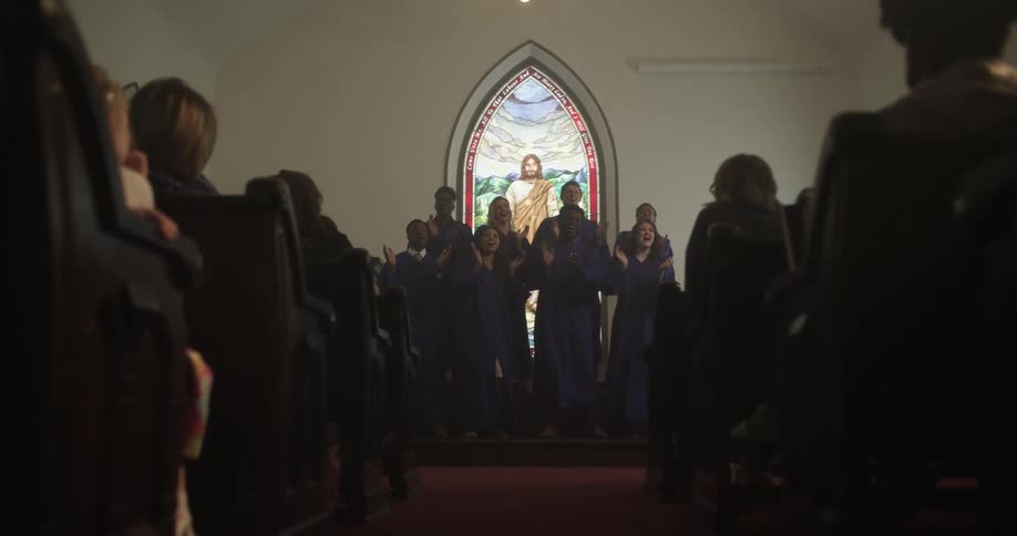 People watch a choir sing at church