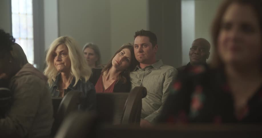 People sitting on church pews listening to sermon