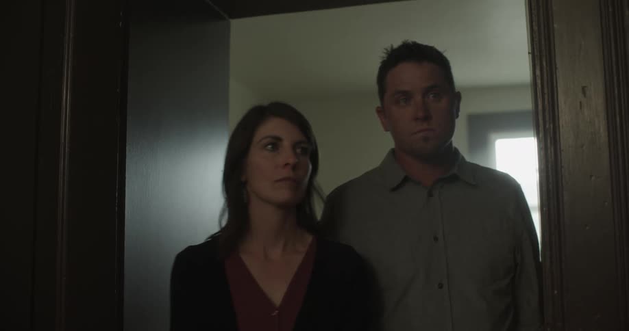 Sad couple walking out of a room and looking around