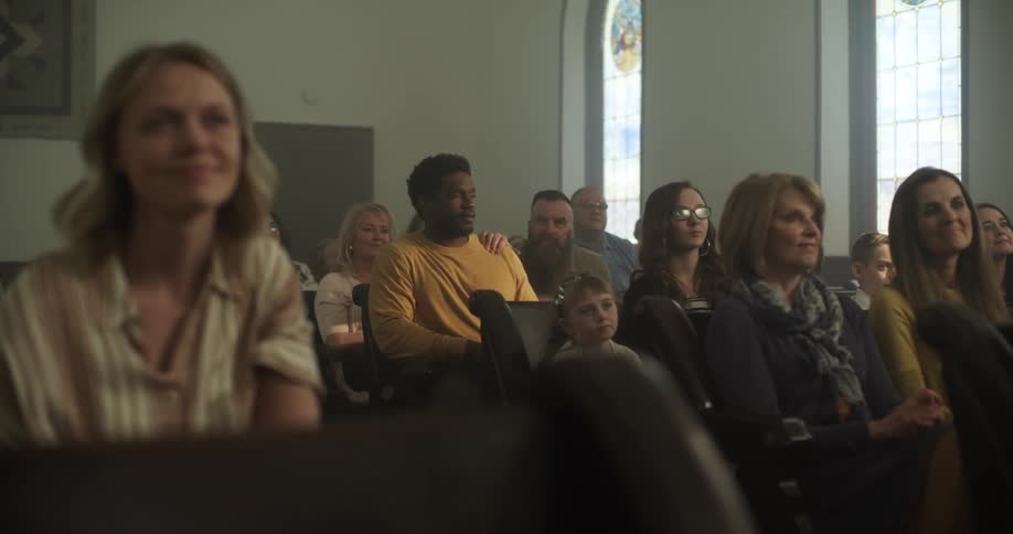 A man walks in to a church with everyone already seated and sits down
