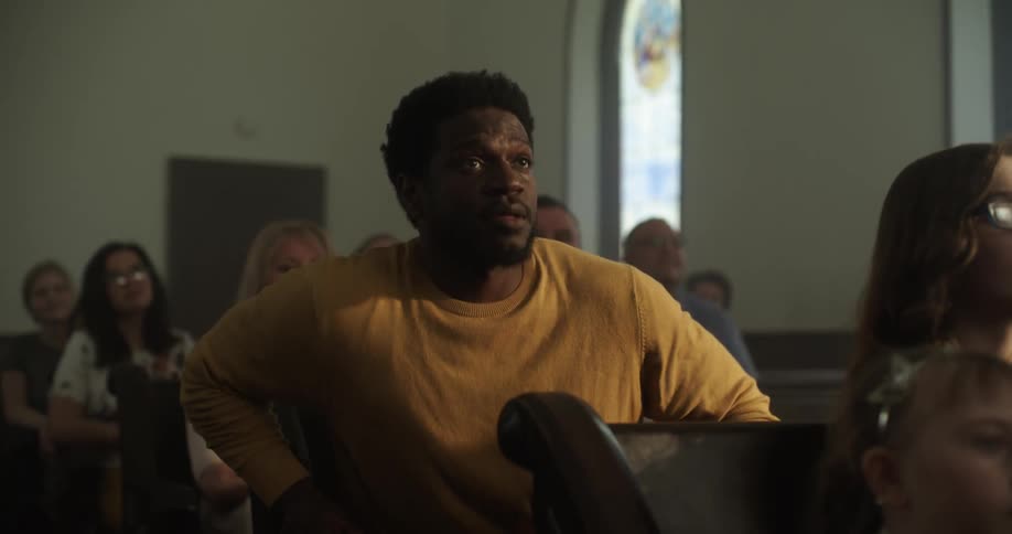 Man greets another who arrived and sat on church pew