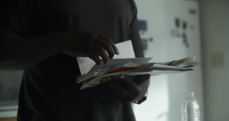 A man is flipping through his mail