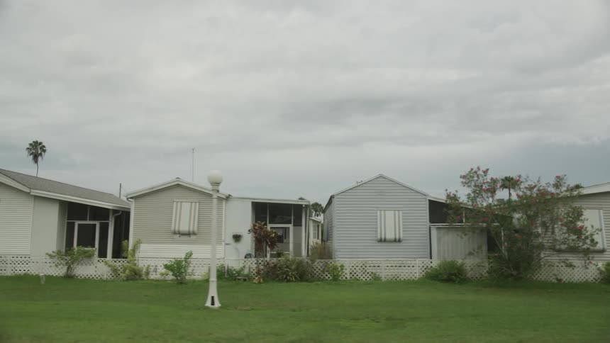 A row of manufactured houses is passed by