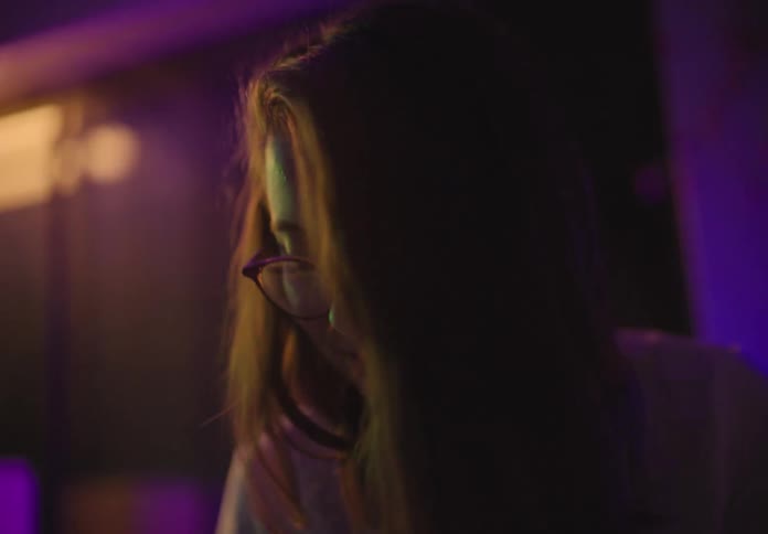 A young teenager dances inside