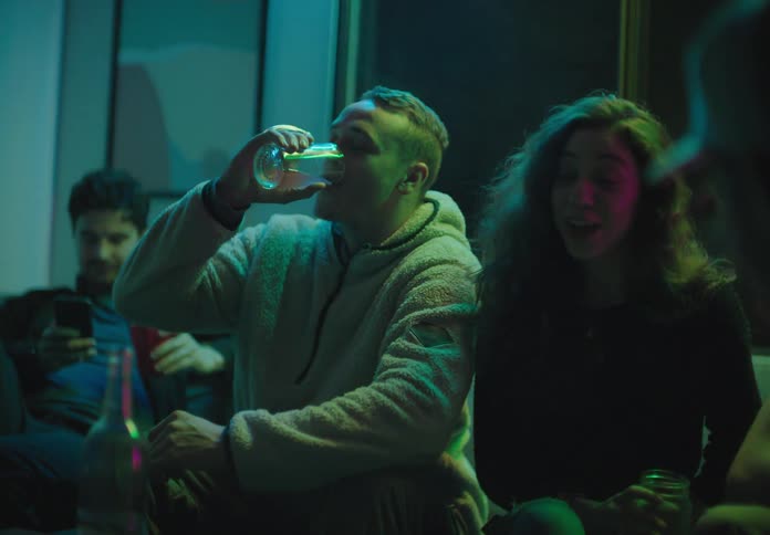People sitting and drinking at a house party