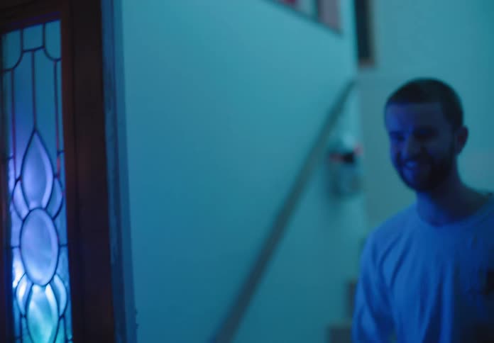 A man walks to another mans front door happy to both see each other